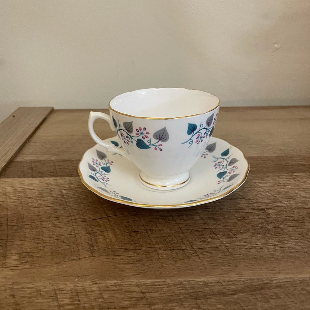 Vintage White Porcelain Teacup and Saucer with Floral Motif